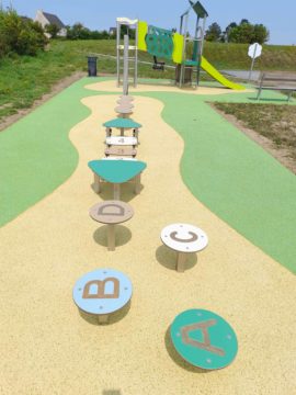 Parc de jeux pour enfants avec parcours éducatif de lettres et de chiffres menant à une structure avec toboggan