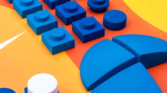 Aire de jeux modulaire LEGO Nike avec briques géantes bleues sur terrain sportif coloré