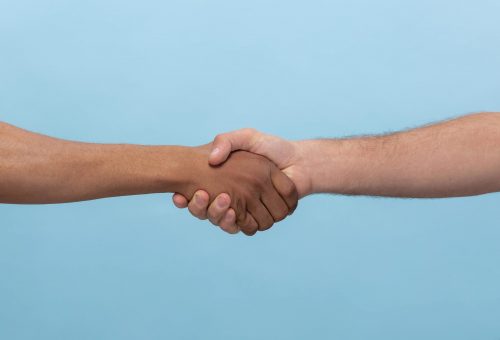closeup-shot-human-holding-hands-isolated-blue-min